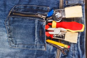 Construction tools in a denim pocket