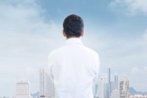 Man in white shirt thinking and looking to the future