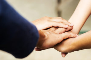 Group of people put their hands together