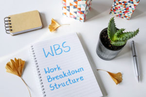 WBS work breakdown structure written in notebook on a white table