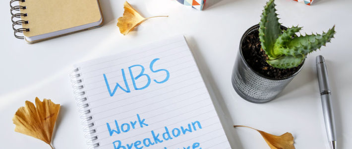 WBS work breakdown structure written in notebook on a white table