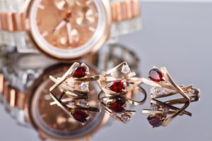 Shiny objects: Golden watch, earrings and rings