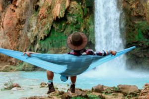 Man with hat sitting in hammock